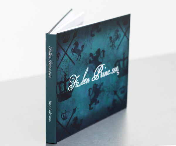 Fallen Princesses hard cover book by photographer Dina Goldstein. A collection of essays, interviews, production secrets and anecdotes about the project.